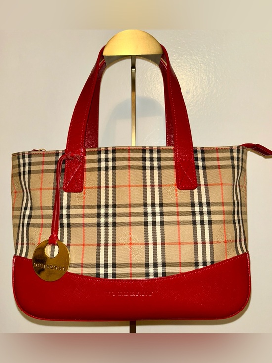 Burberry Handbags - Burberry. Haymarket Check Canvas Tote Bag featuring vibrant red leather trim.